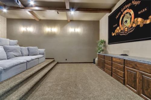a living room with a couch and a large screen at Entertainment Castle - Large Group & Company Func in Meridian