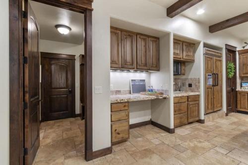 a kitchen with wooden cabinets and a counter top at Entertainment Castle - Large Group & Company Func in Meridian