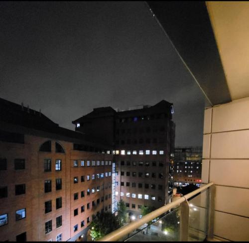 a view of a city at night with buildings at 1 room in shared 2 bedroom apartment R1 in Manchester