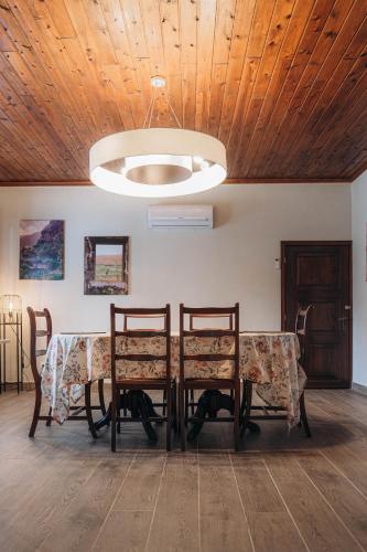 a dining room with a table with chairs and a ceiling at Oceanview Sunset Retreat in Pilar