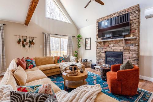 a living room with a couch and a fireplace at The Buckhorn Chalet Hot Tub Arcades 6 Bedroom Fire Place in Albrightsville
