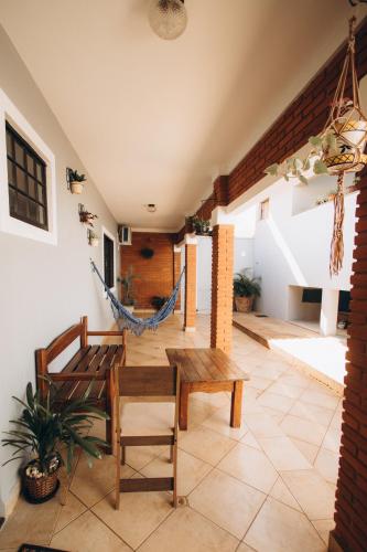 a room with a hammock and a table and chairs at Villa Rio in Brotas