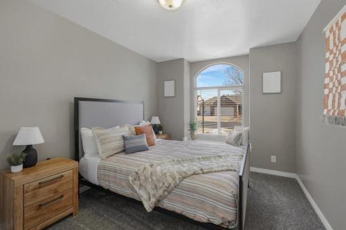 a bedroom with a bed and a window at Spacious Entertainment Dream Home 6 BR Speeps 22 in Syracuse