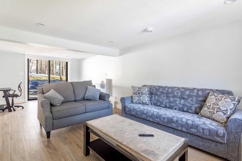 a living room with a couch and a chair at The Woodland Escape Pool Table Fire Pit 4 BD in Tobyhanna