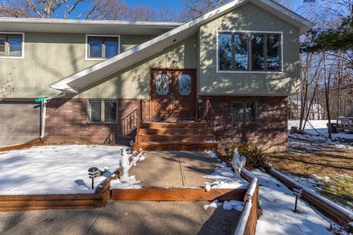 a house with a front door in the snow at The Woodland Escape Pool Table Fire Pit 4 BD in Tobyhanna