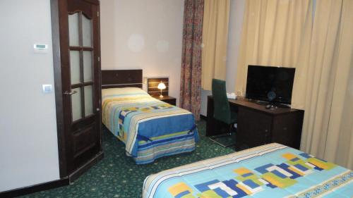 Katil atau katil-katil dalam bilik di Hotel L'auberge Du Souverain