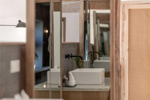 a bathroom counter with a sink and a mirror at Shaxi Ancient Town Shiran Mountain Homestay in Jianchuan