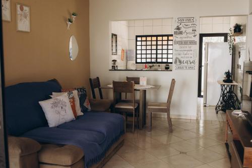 a living room with a blue couch and a table at Villa Rio in Brotas
