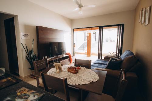 a living room with a table and a couch at Villa Rio in Brotas
