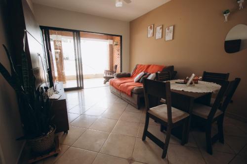 a living room with a couch and a table at Villa Rio in Brotas