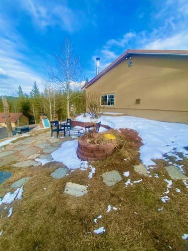 a house with snow on the ground in front of a yard at Rocky Mountain Retreat in Divide