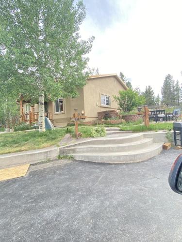 a house with stairs in front of a house at Rocky Mountain Retreat in Divide