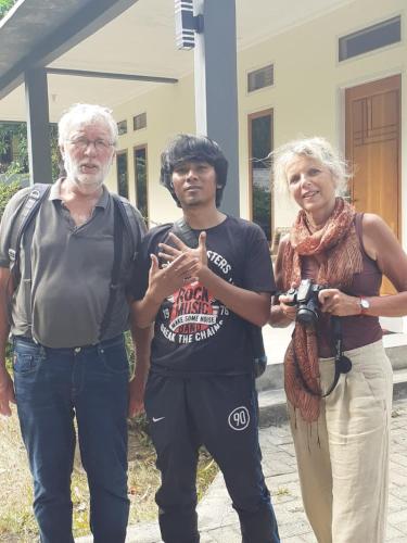 a man and a woman standing in front of a building at Tangkoko Macaca in Rinondoran
