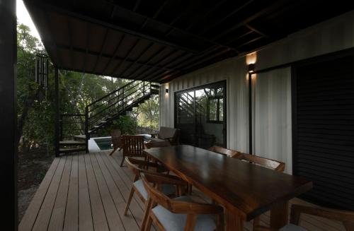 a wooden deck with a wooden table and chairs at Casa Contenedor en Valladolid in Valladolid
