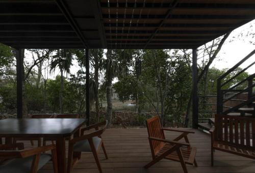 a patio with a table and chairs on a deck at Casa Contenedor en Valladolid in Valladolid