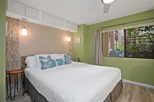 a bedroom with a large bed and a window at Remodeled 1BR at Kihei Ali'i Kai with Free Parking! in Kihei