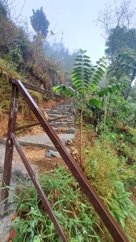 an old wooden gate on a hill with a stone staircase at Kailash villa and restro in Pokhara