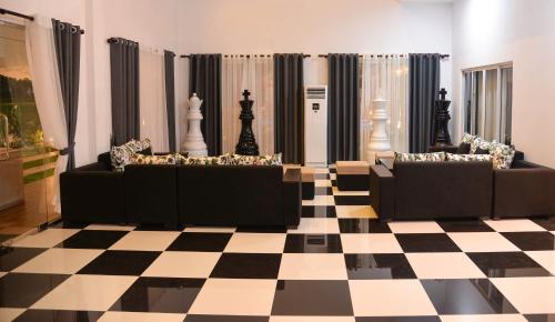 a room with two couches on a checkered floor at The Jungle Dream World in Wadduwa