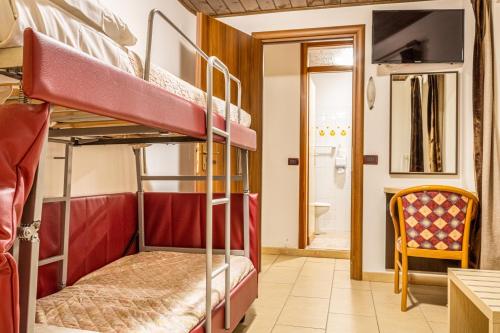 a room with two bunk beds and a bathroom at Residence Orizzonte in Vaneze