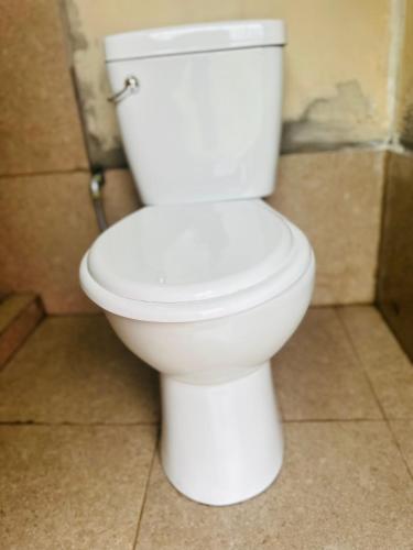 a white toilet sitting in a bathroom at Salkantay Glamp in Colcapampa