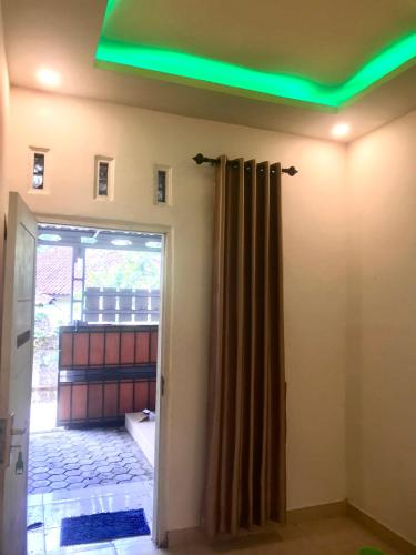 a room with a green light on the ceiling at Lombok Family Homestay in Masbagik