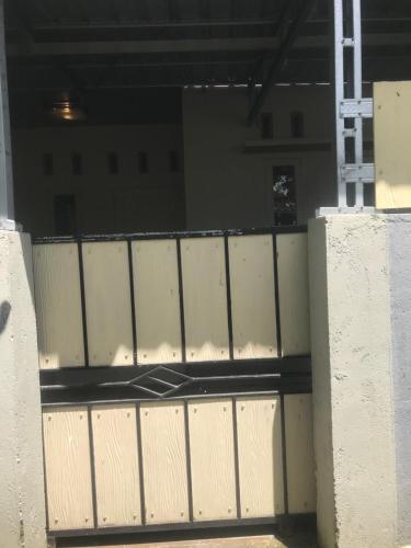 a white gate in front of a building at Lombok Family Homestay in Masbagik