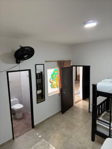 a living room with a toilet and a sink at Casa Encanto in Taganga