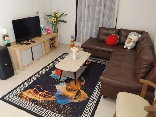 a living room with a couch and a table at Suksabai Raiwan and Pool Villa in Jomtien Beach