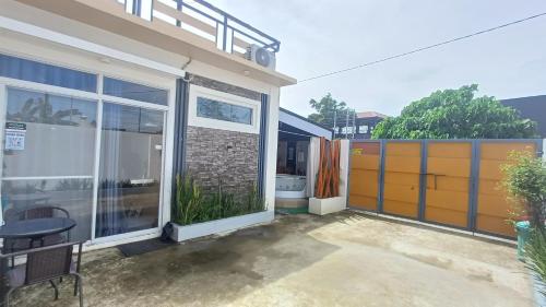 a house with a large window and a patio at BMF Homestay Jacuzzi in Tacloban