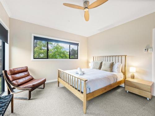 a bedroom with a bed and a chair and a window at Greenview in Margaret River Town