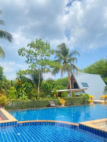 a swimming pool in front of a resort at Infinite Resort and Cafe in Krabi