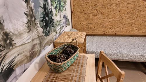 a basket of blackberries sitting on a table next to a bench at guest house אשראם בכרמל - אכסניה in Dāliyat el Karmil