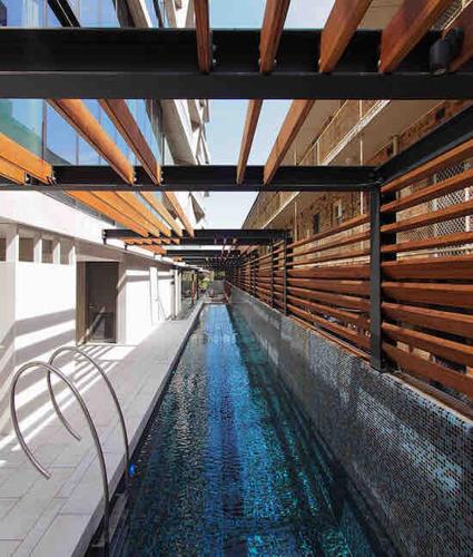 a swimming pool with blue water in a building at Classy 2B apt next to Albert Park w Free Parking#LA09 in Melbourne