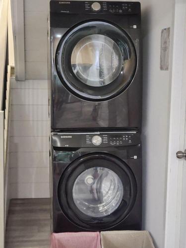 two washing machines sitting next to each other at Gateway to Serenity-Welcome home in London