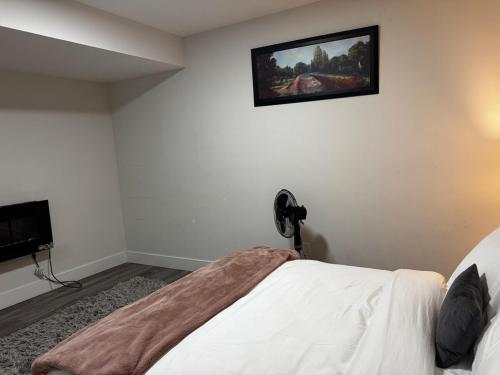 a bedroom with a bed and a painting on the wall at Gateway to Serenity-Welcome home in London