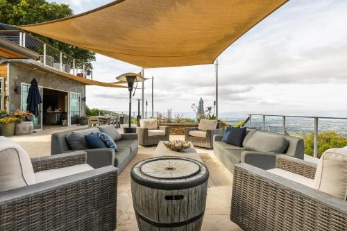 a patio with couches and a table with a clock on it at Montebello Views in Cupertino