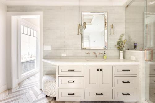 a white bathroom with a sink and a mirror at Montebello Views in Cupertino