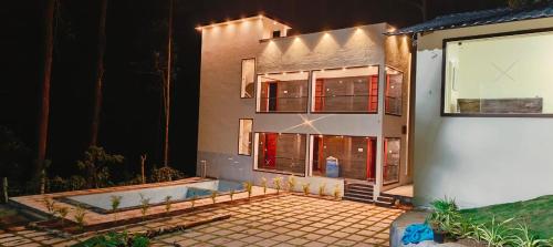 a house is lit up at night at Nature View Resort Yercaud in Yercaud