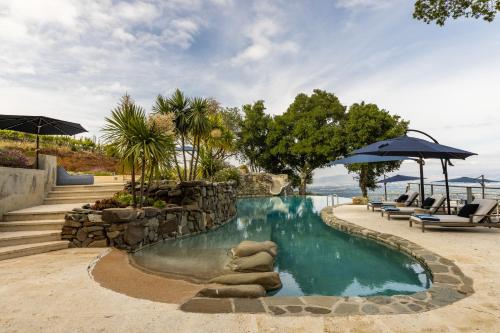 a pool at a resort with chairs and an umbrella at Montebello Views in Cupertino