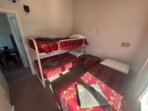 a small room with two bunk beds in it at Westshore Holiday Park in Napier