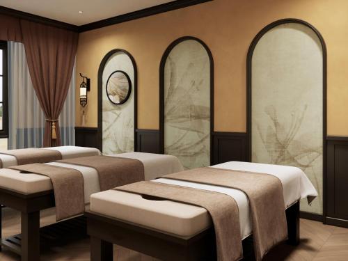 a row of beds in a room with mirrors at Halong Collection Of The Sea Cruises in Ha Long