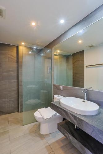a bathroom with a sink and a toilet and a mirror at Mountain View 1 Bed Apt T2-723 in Chalong