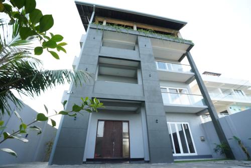 a building with a plant on the top of it at Goalie Beachfront Resort in Hikkaduwa