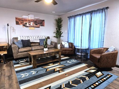 a living room with a couch and chairs and a table at 3Bd, King, Brkfst, Large TVs, WD, Sleeps 11, BBQ in Page