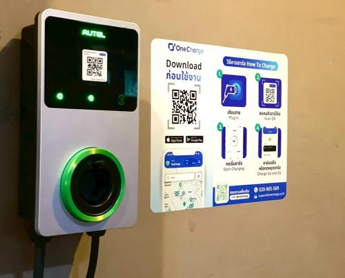 an iphone being hooked up to a charging station at Montree Phuket Hotel in Phuket Town
