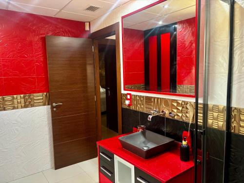 a bathroom with a red sink and a mirror at --CHALET EN ALICANTE-- Piscina Privada in Moralet