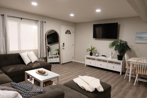 a living room with a couch and a tv at Central San Diego 3BR Home Near Beaches in San Diego