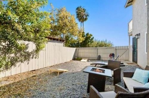a backyard with a fence and a table and chairs at Central San Diego 3BR Home Near Beaches in San Diego