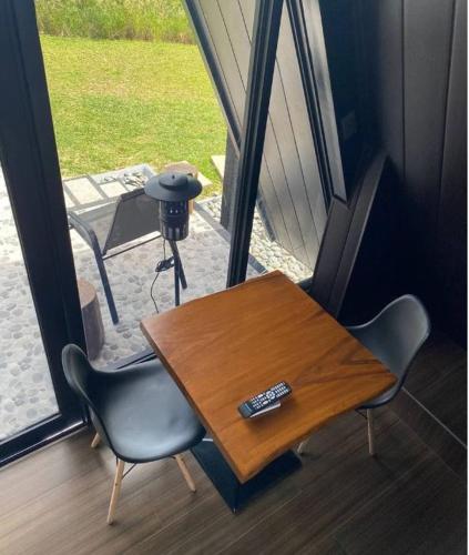 a table and chairs in a room with a window at My Cabin by One Selah in Bustos