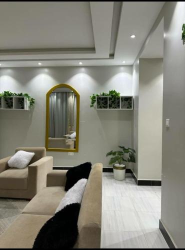 a living room with a couch and a mirror at Ahwera beautiful homes in Kampala